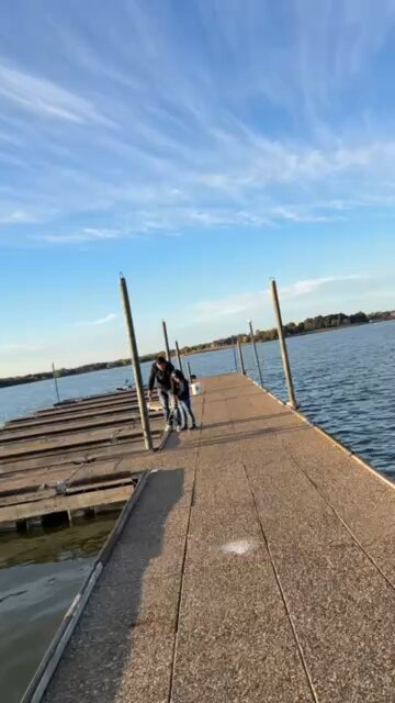 Kid catches a fish with Dad