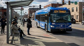 A Newflyer City bus Open the Front door for People to get on board the bus