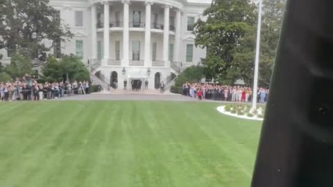 President Donald Trump waves to a crowd of amazing interns at the White House as he takes off in Marine One