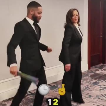 Kamala Harris performs bizarre dance routine with man waving LGBTQI+ fan