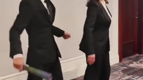 Kamala Harris performs bizarre dance routine with man waving LGBTQI+ fan