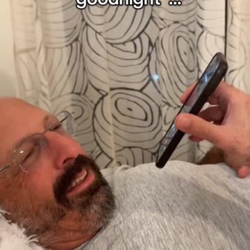 Man calls friend to wish him goodnight.