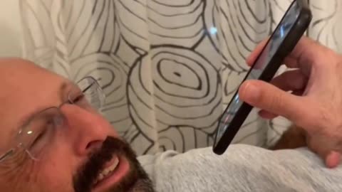 Man calls friend to wish him goodnight.