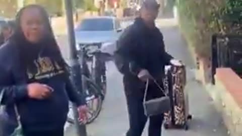 black woman abuses white woman in front of her child in a pram because she said excuse me