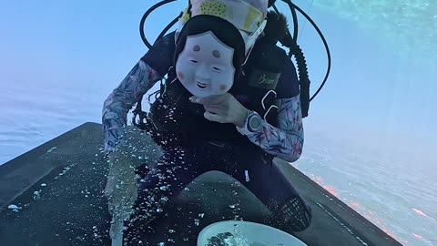 Masked Diver Cleaning Ship Bottom