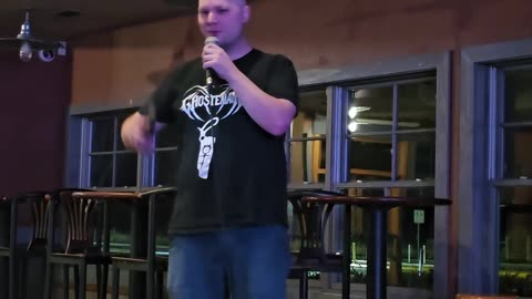 Comedian Riley Hell performing at an IRL open mic