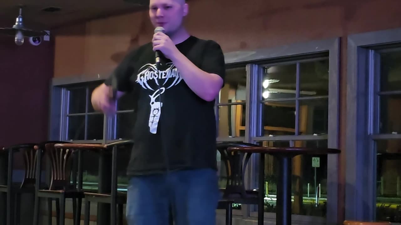 Comedian Riley Hell performing at an IRL open mic