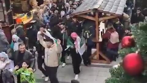 Muslims invade a German Christmas market with their foreign flag protests crap.