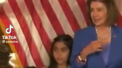 Pelosi elbows a young Mexican Girl for her safety.