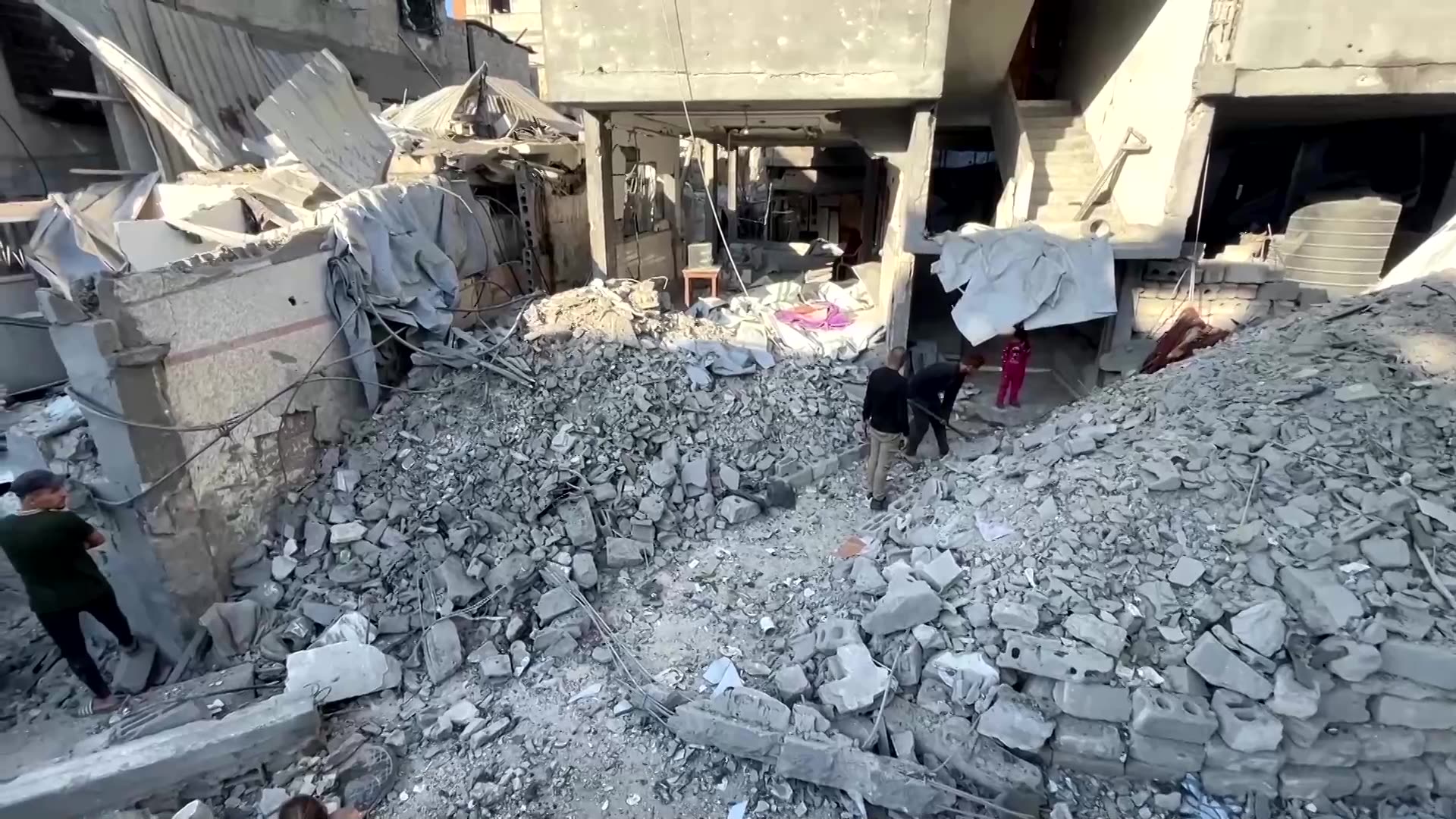 Palestinians inspect the site of Israeli strike in Gazas Jabalia