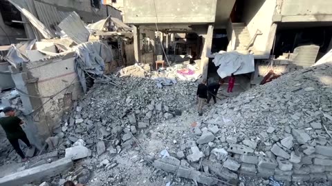 Palestinians inspect the site of Israeli strike in Gaza's Jabalia