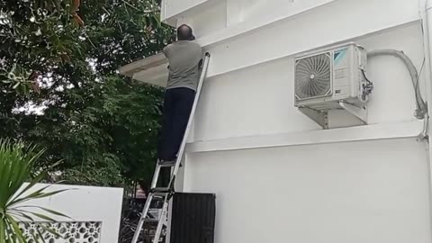 Fixing Broken Cables: Worker Climbing to Repair the Line