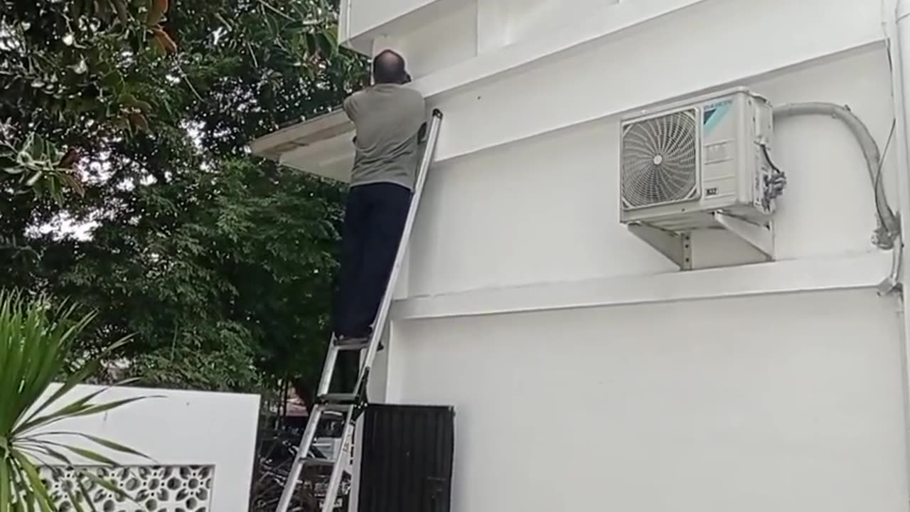 Fixing Broken Cables: Worker Climbing to Repair the Line