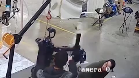 😳Moment humanoid robot attacks handlers as it tries to break free from restraints