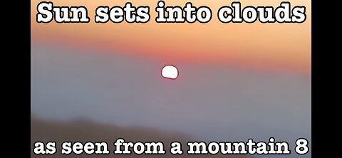 Sun sets into clouds as seen from a mountain 8