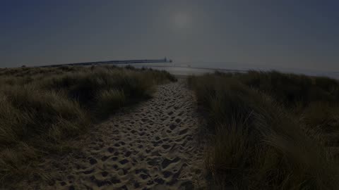 South Beach Blyth Northumberland and West Pier river mouth drone with early sun flat sea
