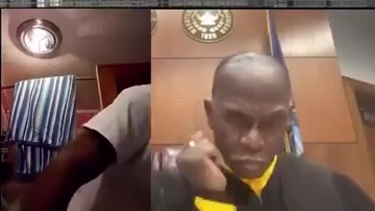 Blk man on video court with the Judge smoking weed