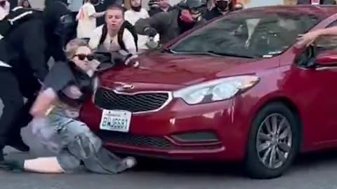 Car runs over a protester while trying to block the vehicle from leaving during protests