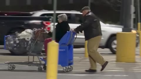 Elderly Man Lovingly Pushes His Wife In Shopping Cart