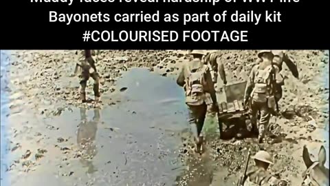British Soldiers Carry Crates Together While Walking in Harsh Muddy Fields