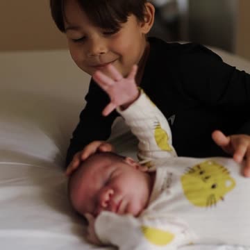 Adorable Sibling Bonding Moment on Bed