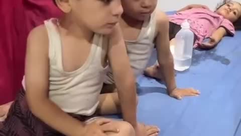 Sibling children injured as a result of Israeli shelling of a house in the central Gaza Strip