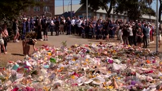 Emergency crews lay flowers at memorial for Bondi shooting victims