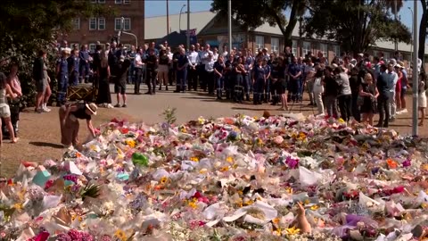 Emergency crews lay flowers at memorial for Bondi shooting victims