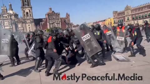 Mexican police kicking protester butt