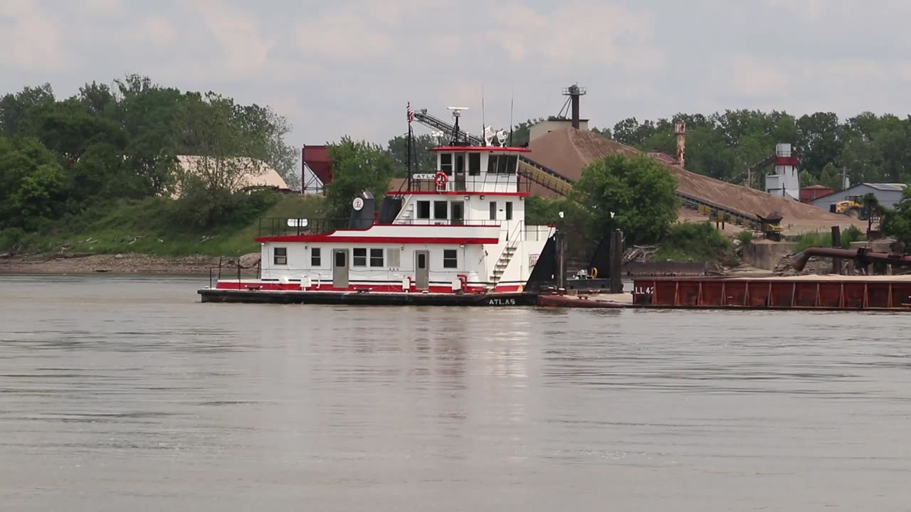 Towboat pushing a river barge up the Missouri River