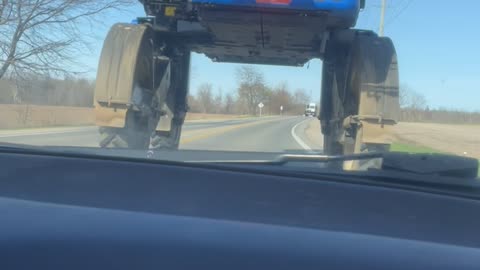 Guys Drive Under a Crop Sprayer