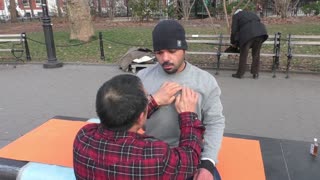 Luodong Briefly Massages Man In Winter Hat At Washington Square Park