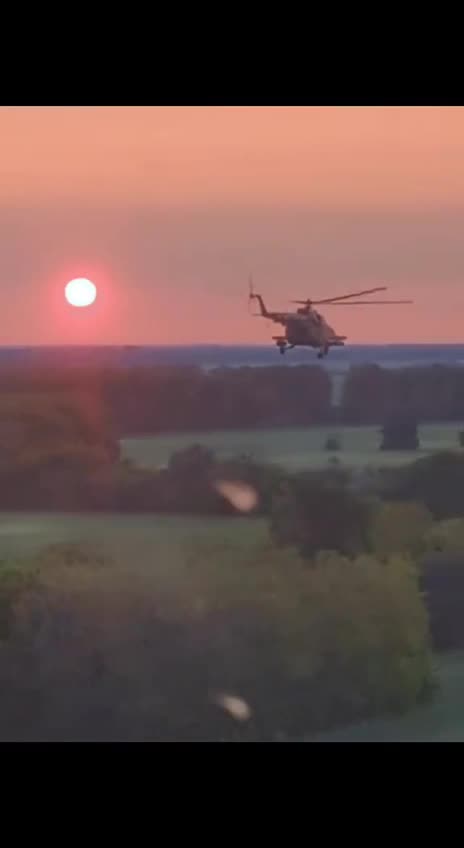 Pair of Ukrainian Helicopters Moving Across Horizon and Sunset