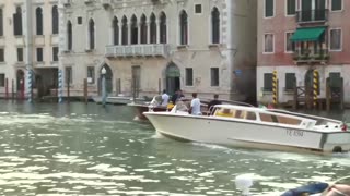 Jeff Bezos and Lauren Sanchez wave as they leave Venice hotel