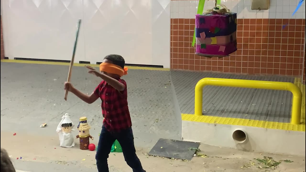 Blindfolded Son Struggles To Strike Pinata