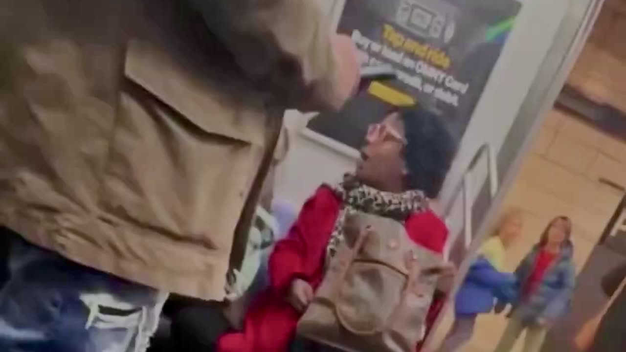 Blàck lady pushes Hispanic lady off seat
