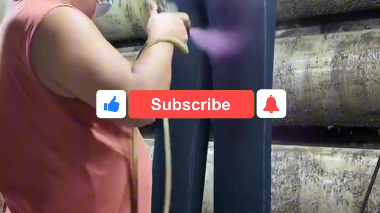 Man Spraying Jeans for Stylish Design at Denim Factory | Behind the Scenes