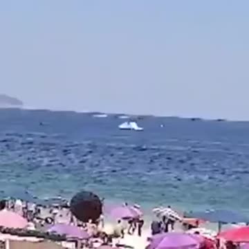 An ultralight plane pulling an advertising banner crashed into the sea off Copacabana beach
