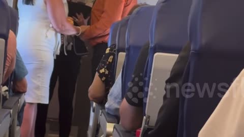 Love is in the air! Couple get married mid-flight, complete with bouquet toss and music on intercom