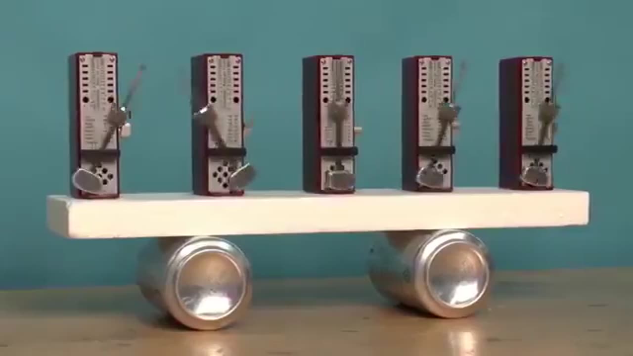 If you put a series of out of phase metronomes on a movable surface they will synchronize themselves spontaneously