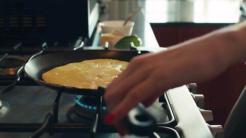 Woman flipping her egg omelet