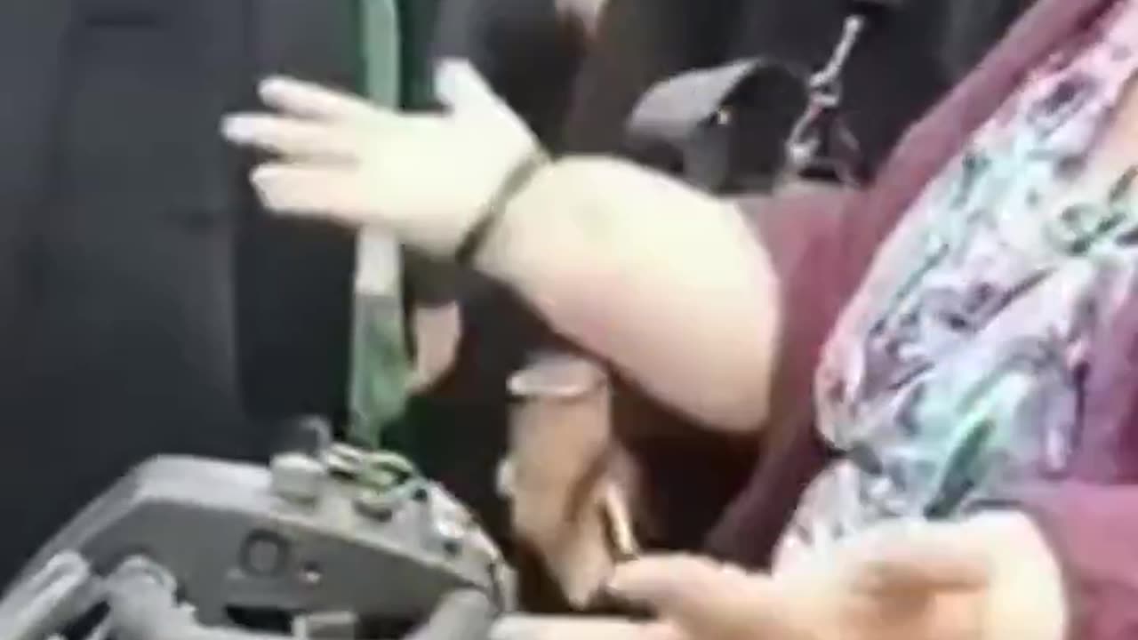 Muslim women block a disabled woman from passing by on the pavement.