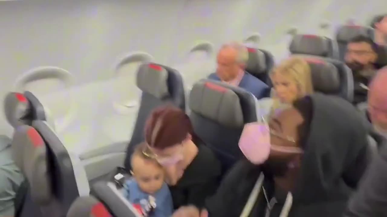 He films RFK Jr taking his seat in a basic economy seat.