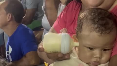 Sports Game Distracts From Bottle Feeding Baby