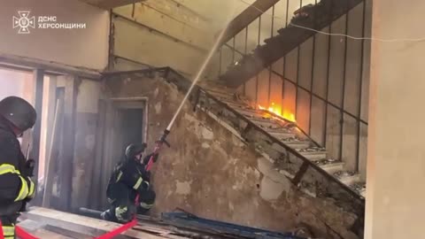 Video of Kherson firefighters extinguishing a building that was on fire after strike