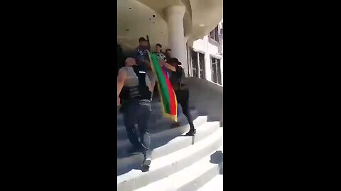 The Druze are waving a Druze flag with a Star of David at the Governor's building in Sweida.