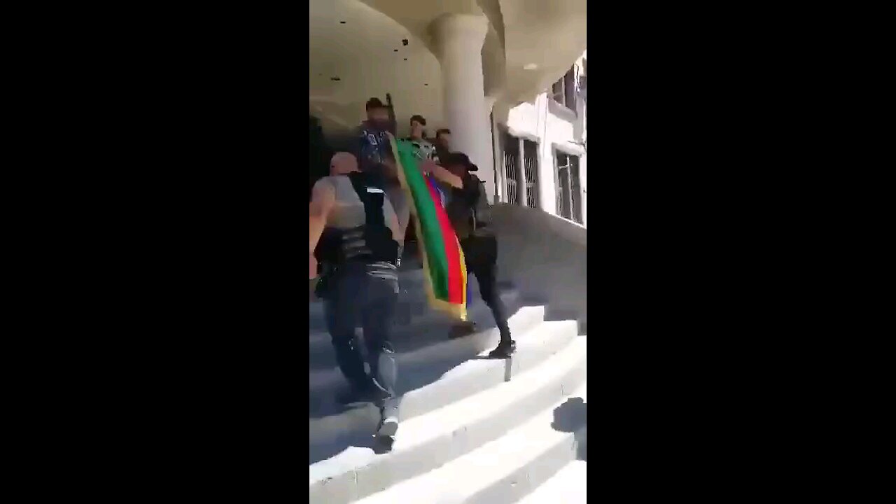 The Druze are waving a Druze flag with a Star of David at the Governor's building in Sweida.