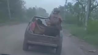 Russian Soldier Dumped Out the Back of Moving Vehicle