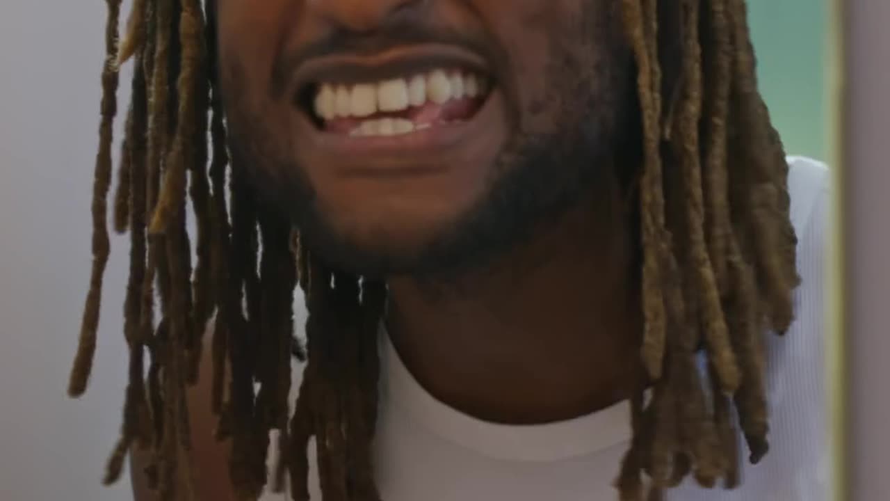 A joyful man belts it out in front of the mirror, using a toothbrush as a mic.