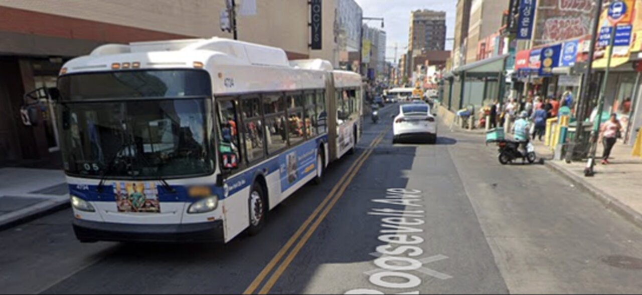 Q12 MTA CITYBUS IS DRIVING ON THE ROAD IN FLUSHING MAIN STREET